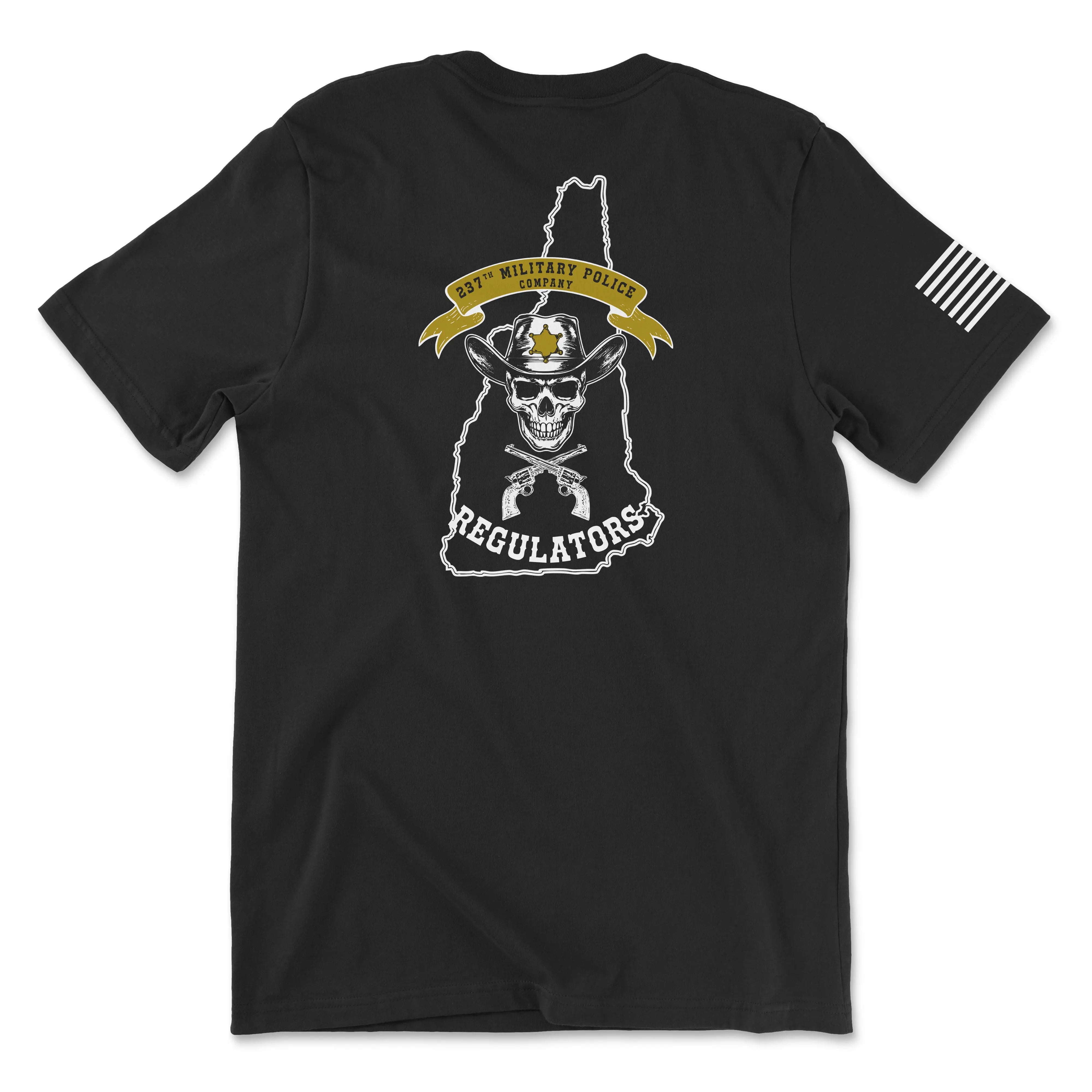 Back view of a black t-shirt for the 237th Military Police Company. The design features a skull wearing a blue beret and a gas mask, set against a white outline of the state of Massachusetts. A yellow banner reads '237th MILITARY POLICE COMPANY' above crossed flintlock pistols and the word 'REGULATORS' in white. A white American flag patch is visible on the right sleeve.
