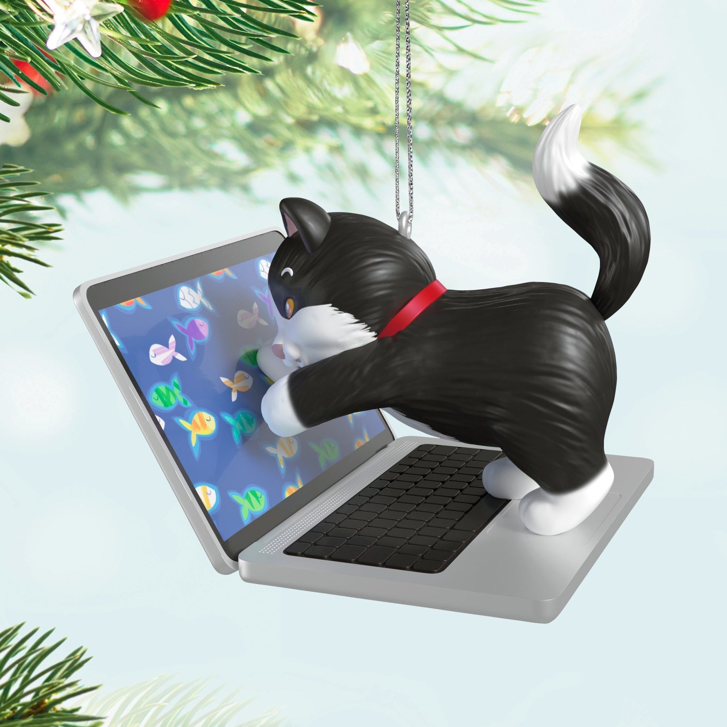 Mischievous Kittens, 27th in the Series — 2025 Hallmark Keepsake Christmas Ornament, black-and-white tuxedo cat on laptop with fish images, close up view.